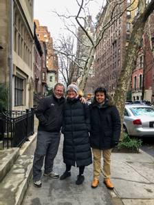A group of people posing for a photo on a sidewalk  Description automatically generated with low confidence